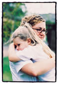 Salvation Army woman hugging a child